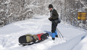 Pulling winter sled through snow