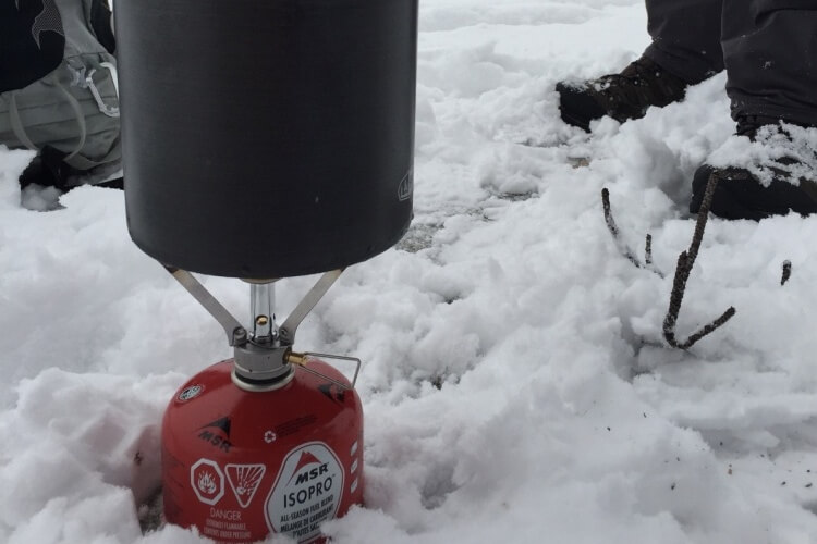 Winter camping stove in snow