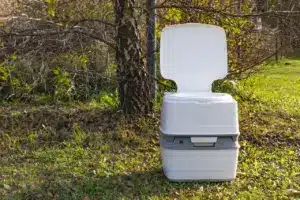 A Portable Plastic Toilet on the Ground