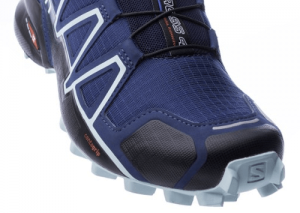 Close-up of a blue and black trail running shoe with prominent branding and rugged sole designed for hiking and grip.