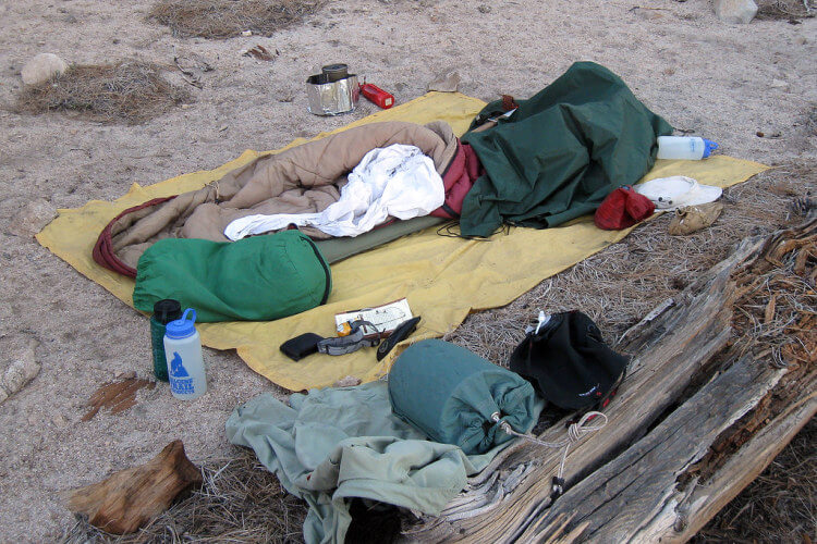 Cowboy Camping gear including ground sheet, sleeping pad, and sleeping bag