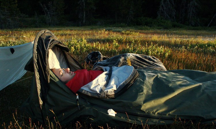 Man sleeping in bivy shelter