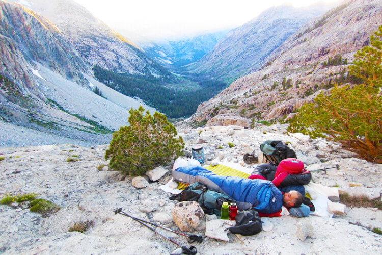 Backpackers camping in mountains without tent