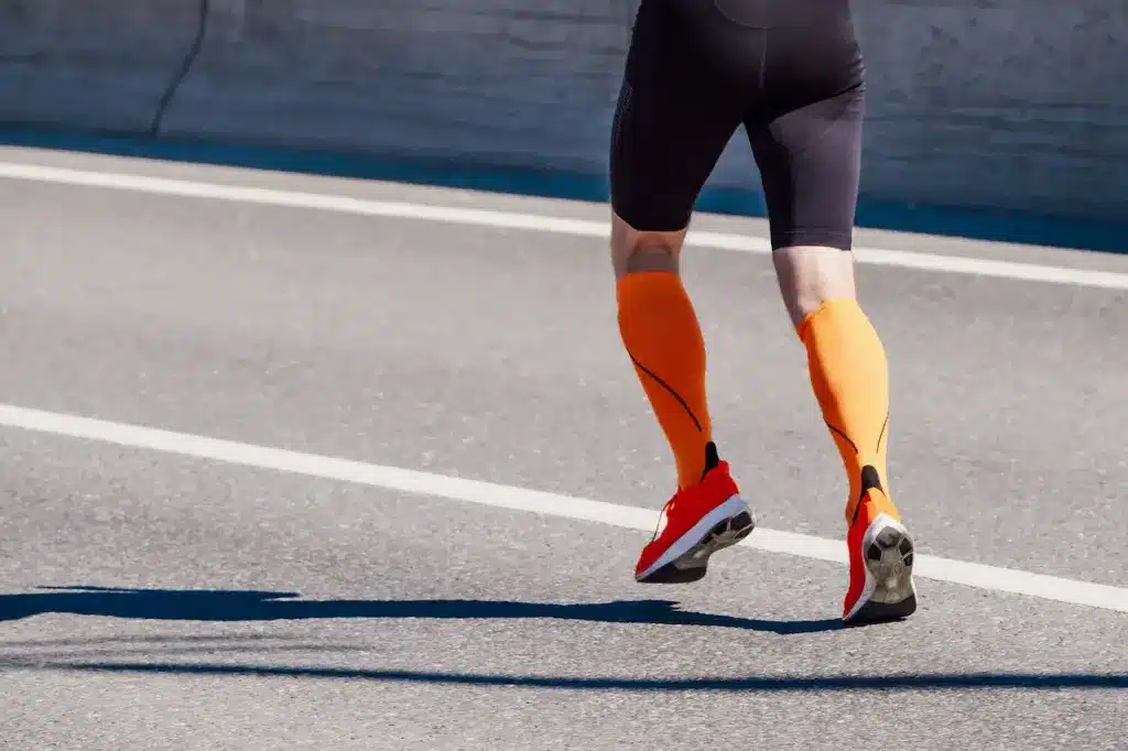 Best Compression Socks, ,Male Runner Wearing Orange Socks and Rubber Shoes