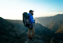 Best Hiking Backpacks Australia Person Standing On The Top Of The Mountain