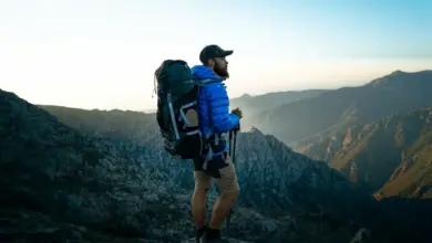 Best Hiking Backpacks Australia Person Standing On The Top Of The Mountain
