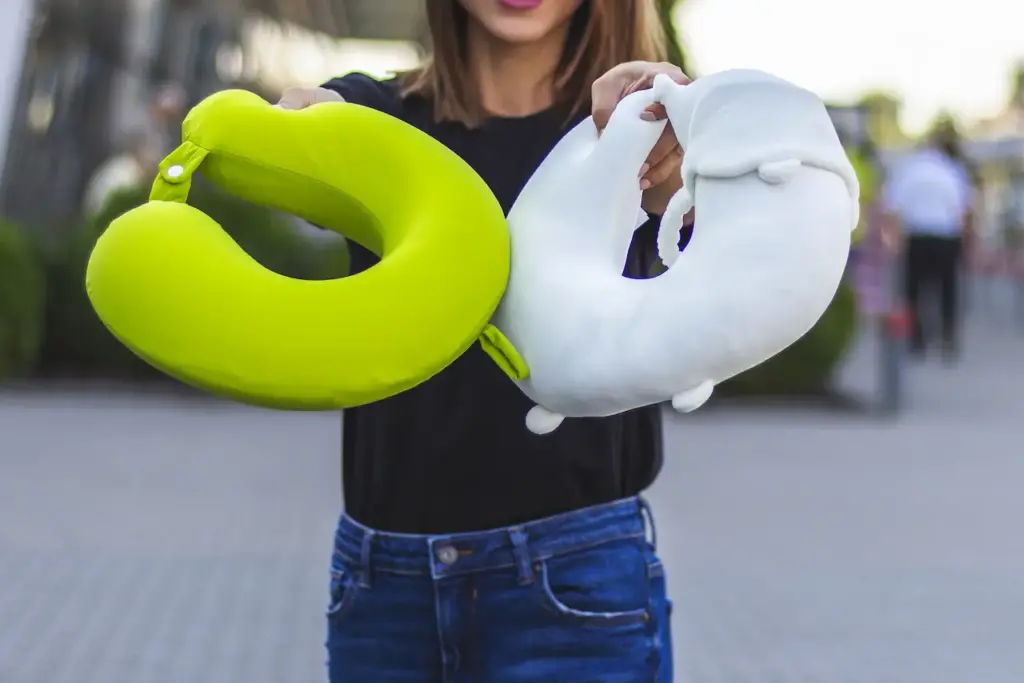 Woman Holding Two Travel Pillows, Best Travel Pillows