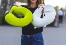 Woman Holding Two Travel Pillows, Best Travel Pillows