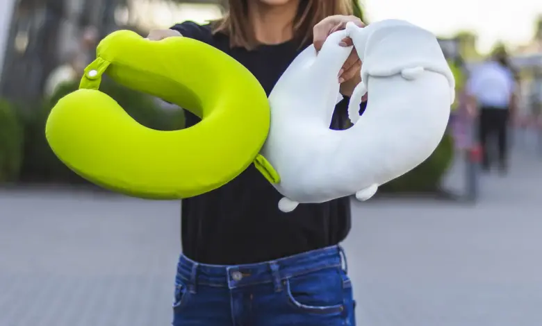 Woman Holding Two Travel Pillows, Best Travel Pillows